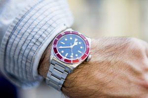 Wristwatch on a male model's hand showing time