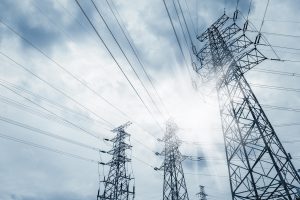power transmission tower against blue sky at dusk